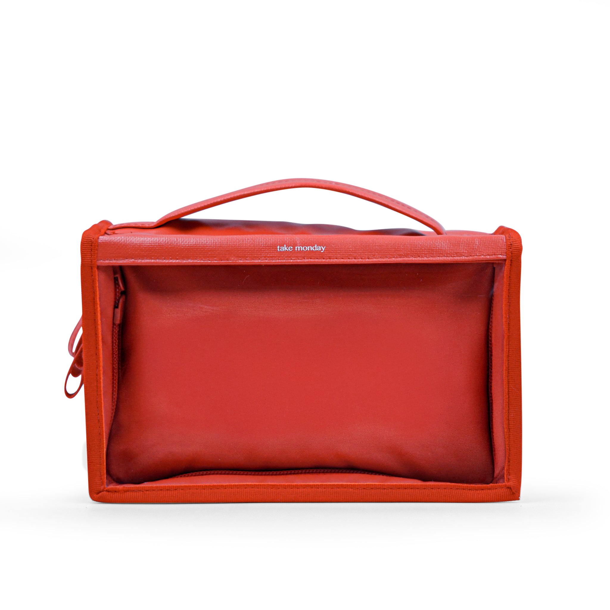 Digital product photograph of a Take Monday vibrant red rectangular travel pouch featuring a sturdy top handle, a discreet side zipper, and the brand name take monday printed on the front flap against a crisp white studio background